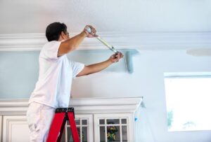 Close up of house painter painting residential home interior