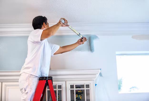 Close up of house painter painting residential home interior